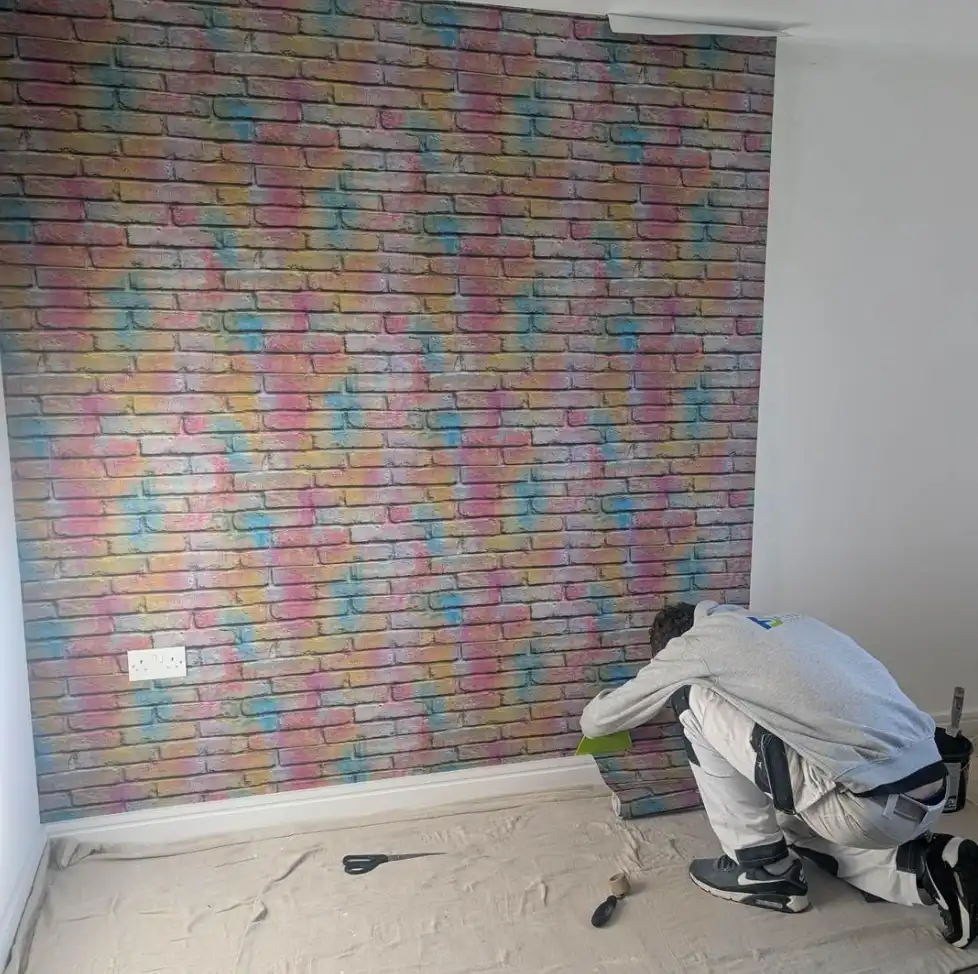 Brick effect wallpaper being installed by Fineline Decorators Plymouth, Devon & Cornwall